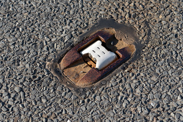 Catseyes set in cast iron frame a retroreflective road safety devicet in the middle of the road