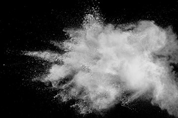 White powder explosion isolated on black background. White dust particles splash.Color Holi Festival. - obrazy, fototapety, plakaty