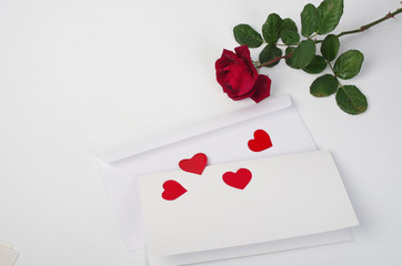 Love letter. Envelope, pen, red hearts and a rose.