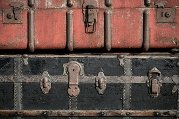 Old vintage antique suitcases trunks in a stack background 