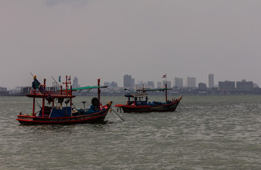 Fototapeta na wymiar Thai wooden fishing boats at anchor near the shore