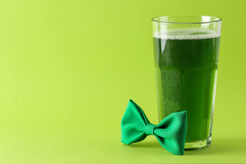 St.Patrick 's Day. celebration. green beer and bow tie on a bright green background. space for text