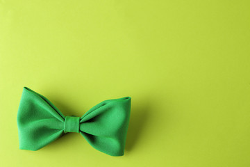 St.Patrick 's Day. celebration. Green tie butterfly leprechaun on a bright green background. top view. space for text