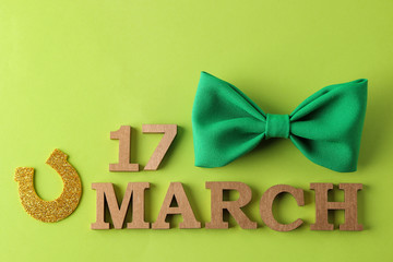 St.Patrick 's Day. celebration. Green bow tie and horseshoe and text March 17 on a bright green...