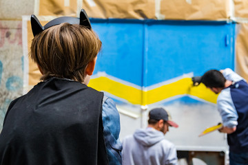 A kid watching  street art paintings in Madrid, Spain