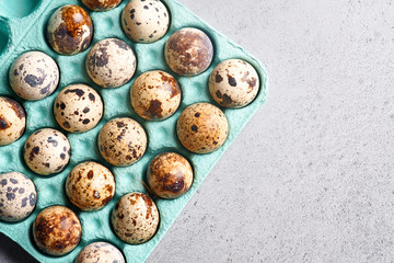 Quail eggs in blue cardboard packaging