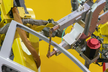 The robotic arm spot welding the car door  parts. The hi-technology automotive part manufacturing...