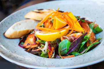 grilled salmon and lemon - french cuisine dish with tomato and salmon