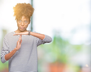 Beautiful young african american woman wearing glasses over isolated background Doing time out...