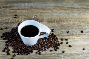 Coffee Cup and Coffee bean on wood table