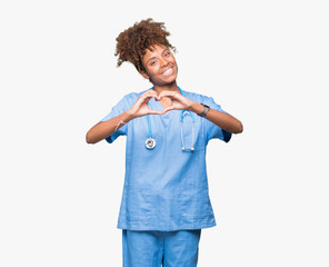 Young african american doctor woman over isolated background smiling in love showing heart symbol...