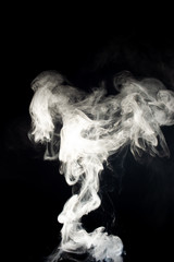 Obraz na płótnie Canvas Vape steam spread with spray boiling liquid. Stock photo isolated on black background. Vape culture outreach. Conceptual image.
