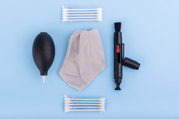 Top view of Camera equipment or accessory kit for cleaning isolated on blue background