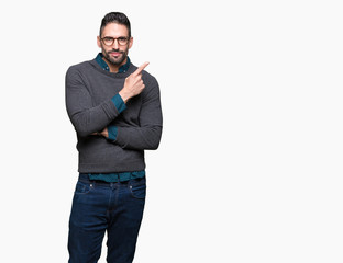Fototapeta premium Young handsome man wearing glasses over isolated background Pointing with hand finger to the side showing advertisement, serious and calm face
