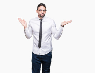 Young handsome business man wearing glasses over isolated background clueless and confused...
