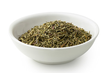 Dried rubbed thyme in a white ceramic bowl isolated on white.