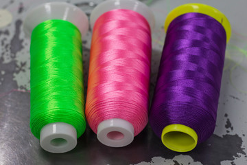 colored thread for machine embroidery, acid colors, lie on the surface