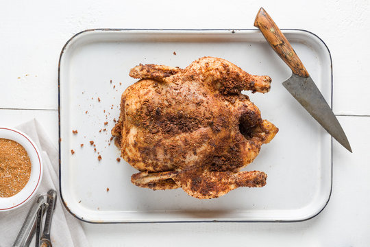 A whole roasted chicken rubbed with cumin, coriander, cayenne, sweet paprika, chili powder, onion and garlic.