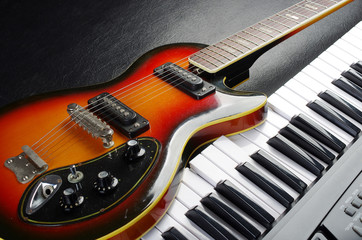 Obraz premium Electric guitar and piano keyboard.