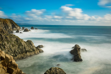 Fototapeta na wymiar Long exposure of waves crashing along the California coast near San Francisco.
