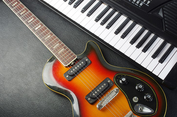 Fototapeta na wymiar Electric guitar and piano keyboard.