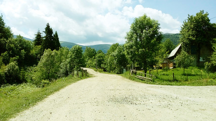 Fototapeta na wymiar country road in the mountains on a clear summer day
