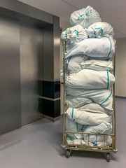 Collected laundry bags in the hospital are transported in a transport box. Concept: Health and...