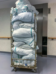 Collected laundry bags in the hospital are transported in a transport box. Concept: Health and hygiene
