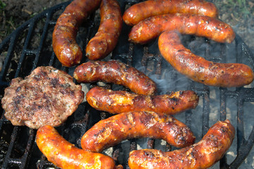 Sausages and hamburger patties on the BBQ