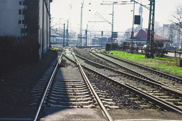 Railway tracks in the countryside with track bed. Gravel and switch at a railroad crossing