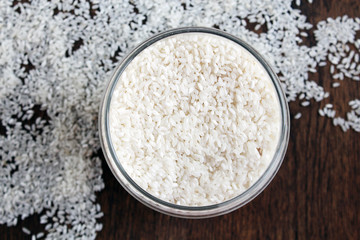 white rice in can on a wooden table