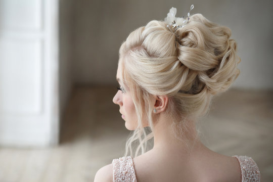 Portrait of a blonde bride with an elegant wedding hairstyle in profile.