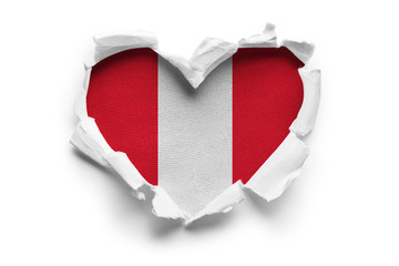 Heart shaped hole torn through paper, showing satin texture of flag of Peru. Isolated on white...