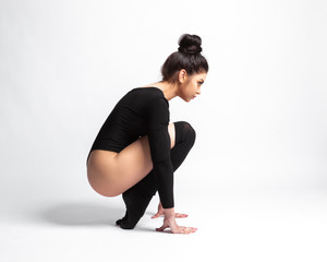Obraz premium beautiful brunette in a black body on a gray background