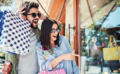 Young couple in shopping. Consumerism, love, dating, lifestyle concept