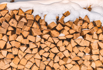 Pile of chopped lumber covered with snow