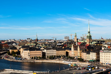 View onto Gamla Stan with Tyska kyrkan and typical Stockholm city houses at the waterfront as seen from Södermalm (Stockholm, Sweden, Europe)