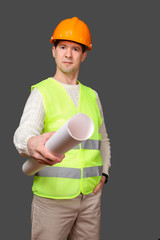 the civil engineer in a helmet gives documents, stretches drawings forward