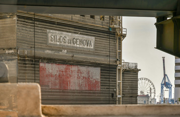 Framed view of the Old Port of Genoa with the Hennebique Silos (1901) and the ferris wheel in the...