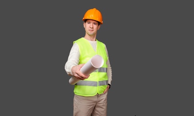 the civil engineer in a helmet gives documents, stretches drawings forward