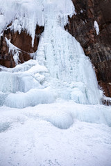 Frozen ice on rocks from a waterfall in the mountains