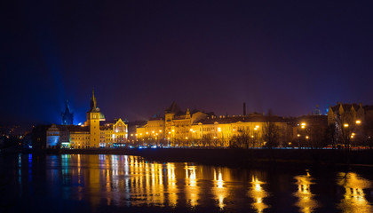 Obraz na płótnie Canvas Night view of Vltava river, bridges and the city from the river shore. Night lights. Prague, Czech Republic