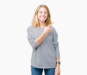 Beautiful young woman wearing stripes sweater over isolated background cheerful with a smile of face pointing with hand and finger up to the side with happy and natural expression on face