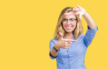 Beautiful young business woman over isolated background smiling making frame with hands and fingers...