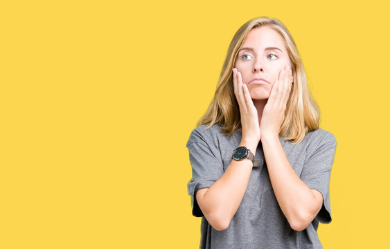 Beautiful young woman wearing oversize casual t-shirt over isolated background Tired hands covering face, depression and sadness, upset and irritated for problem