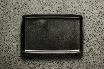 Various cast iron skillets and pans on dark background. Selective focus, space for text.