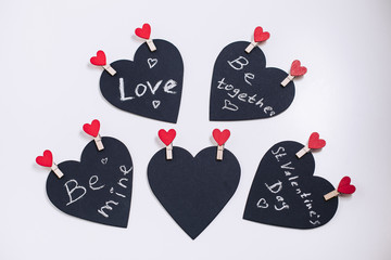 Black valentines with love text, carved from fabric with decorative clothespins