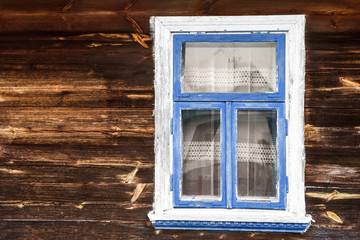 Fototapeta na wymiar Wooden rustic window in small cottage house. Vintage brown wood wall with transparent glass window.