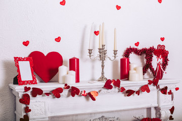 White fireplace with decorations on the day of the holy valentine. Decorative items and accessories