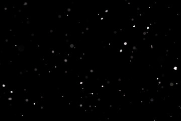Snowstorm texture. Bokeh lights on black background, shot of flying snowflakes in the air